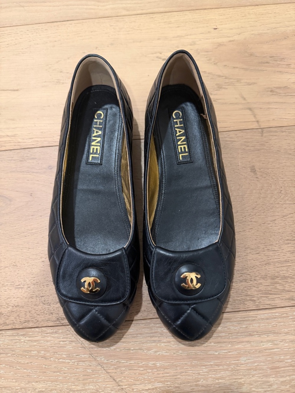 CHANEL Black Quilted Leather Flats with Gold CC Medallion